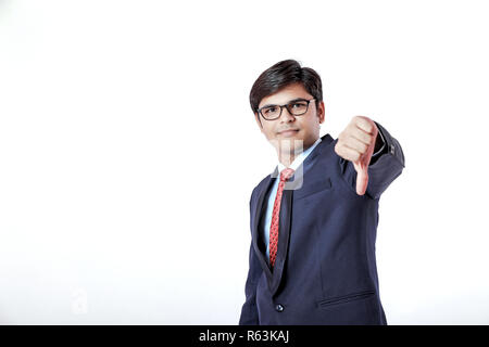 Young Indian businessman showing thumb down Banque D'Images