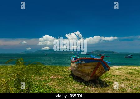 Donnant sur la mer de Chine du sud dans la baie de Nha Trang sur une belle journée ensoleillée avec un bateau de pêche vietnamien au premier plan. Banque D'Images