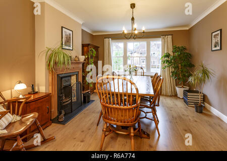 Intérieur salle à manger traditionnelle avec cheminée, meubles en bois, table et chaises Banque D'Images