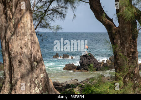 LaupÄhoehoe LaupÄhoehoe - Hawaï, Point. Un homme en équilibre sur les rochers tandis que la pêche dans les vagues. Banque D'Images