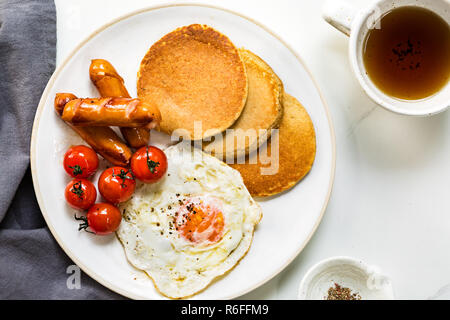 L'avoine banane crêpes avec saucisses, œufs frits et tomates cerises Banque D'Images