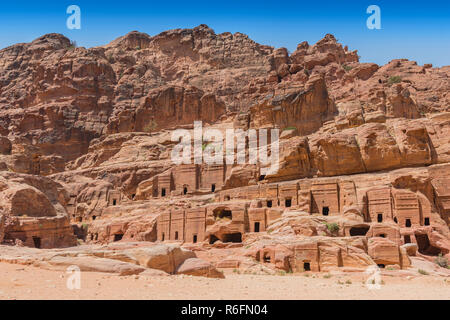 Vue sur Grand côté falaise tombe taillée dans le beau grès Richly-Colored dans la ville antique de Petra, Jordanie Banque D'Images