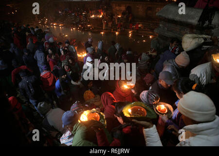 Katmandou, Népal. 6e Dec 2018. Les dévots népalais lights lampes à huile à la mémoire d'un membre est décédé au cours de Bala Chaturdashi festival au temple de Pashupatinath. Bala Chaturdashi est célébrée en mémoire des membres de la famille par l'éclairage des lampes à huile et de dispersion 7 types de grains connu sous le ATSIJ' le long d'un itinéraire prescrit. Credit : SOPA/Alamy Images Limited Live News Banque D'Images