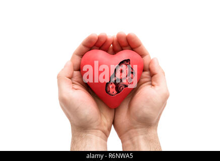 Coeur mécanique rouge en mains isolated on white with clipping path Banque D'Images