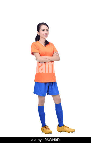 Jeune joueur de football asiatique en orange jersey debout Banque D'Images