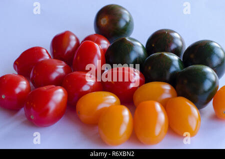 Une variété de tomates en groupe sur fond blanc Banque D'Images