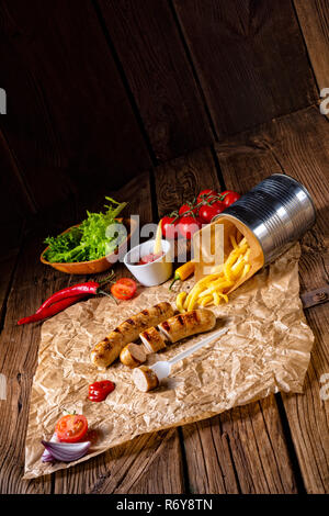 Bratwurst rustique avec pommes et ketchup fort Banque D'Images