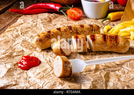 Bratwurst rustique avec pommes et ketchup fort Banque D'Images