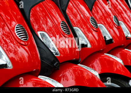 Groupe de trois scooters rouge, disposées en rangée, garées à l'extérieur Banque D'Images