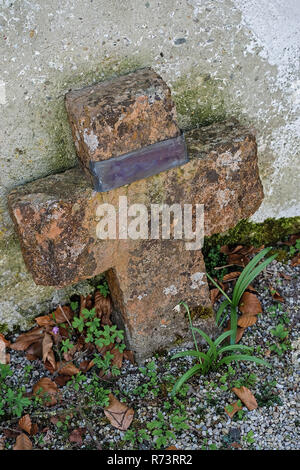 Vieille croix de pierre à un cimetière oublié Banque D'Images