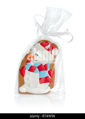 Le Snowman gingerbread en emballage transparent avec un archet. Isolées. Banque D'Images