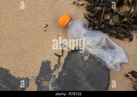 Petite bouteille de boisson d'eau en plastique sur une plage Banque D'Images