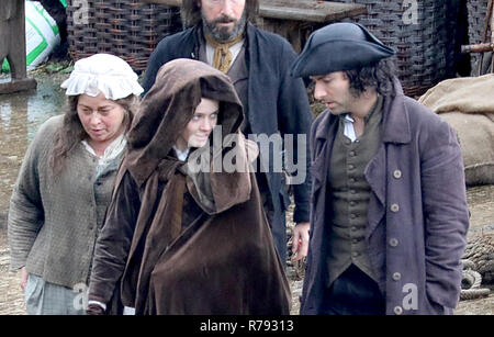 Aiden Turner promenades autour de l'ensemble dans le port avec un mystère dame et l'aide à le navire amarré, plus tard dans la scène son écran femme joué par Eleanor Tomlinson boards le bateau. Les acteurs doivent faire face à une pluie torrentielle que les derniers jours de tournage se produit pour la toute dernière série de 'Poldark' par la BBC. Comprend : Aiden Turner Où : St Austell, Royaume-Uni Quand : 07 Nov 2018 Crédit : David Sims/WENN.com Banque D'Images