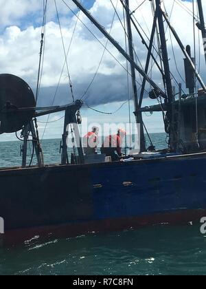 Deux membres de l'équipage de la Garde côtière canadienne bataille Chêne un incendie à bord du navire de pêche Juniper après leur salle des machines a pris feu à Nantucket Sound le 11 mai 2017. Le commandant a signalé l'incendie de plus de 16 Ch. à environ 8:50 heures du matin, on n'a signalé aucun blessé. Banque D'Images