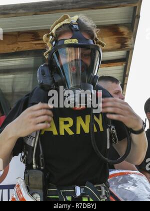 Le sergent de l'armée américaine. Emily Sherlock, un produit chimique, biologique, radiologique et nucléaire (CBRN), officier du rang attribué à la 637ème Compagnie CBRN, se prépare à déposer son équipement de protection chimique après tenue de protection chimique de la formation de la confiance de l'eau, le 29 novembre 2018, Camp Arifjan, au Koweït. Des soldats dans l'armée américaine zone centrale d'opérations sont en constante formation pour être prêt à "combattre ce soir." Banque D'Images