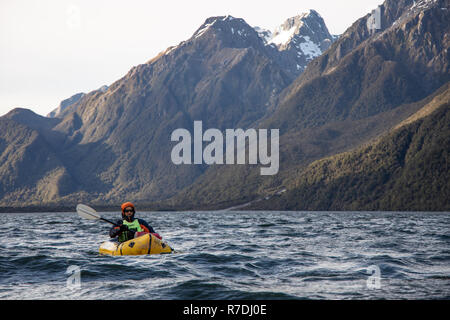 Sur le lac Packrafting Bolton-est dans Parc National de Fiordland, Nouvelle-Zélande Banque D'Images