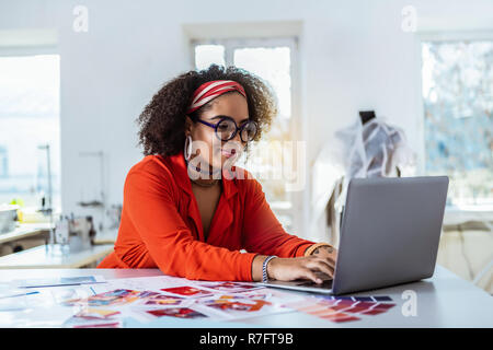 Smiling African American female designer assis dans son studio Banque D'Images