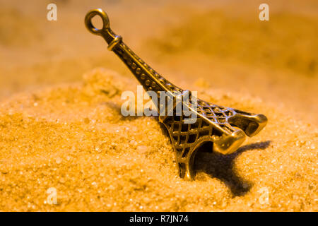 Toy Tour Eiffel dans le sable jaune close-up Banque D'Images