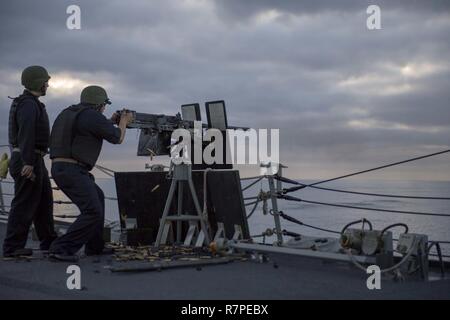 Océan Pacifique (20 mars 2017) Chef d'Master-At-Arms Andres Mejia tire une mitrailleuse de calibre .50 Au cours d'un exercice de tir réel à bord de la classe Arleigh Burke destroyer lance-missiles USS Shoup (DDG 86) pendant qu'ils sont en cours pour l'unité de formation composite (exercice COMPTUEX) avec le groupe aéronaval du Nimitz en préparation pour un prochain déploiement. COMPTUEX teste la préparation aux missions de la grève actifs du groupe grâce à une simulation des scénarios du monde réel et leur capacité à fonctionner comme une unité intégrée. Banque D'Images