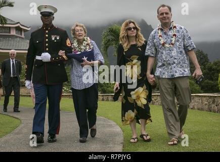 Le s.. Kendrix D. Graham escorts Nancy, Debbie et Scott Hazelbaker après le service commémoratif pour les retraités le Col Marin Vincil W. Hazelbaker, à la Hawaiian Memorial Park Cemetery le 24 mars 2017. Après la cérémonie, les hélicoptères de la Marine Aircraft Group 24 a effectué une formation de l'homme manquant, qui est un salut aérien effectué pendant un défilé aérien d'avions à un événement commémoratif, généralement à la mémoire d'un pilote tombé. Hazelbaker était un aviateur de Marine qui a servi dans l'armée depuis 34 ans. Au cours de son service, il a effectué plus de 680 missions de combat et gagné la Navy Cross pour ses extraordin Banque D'Images