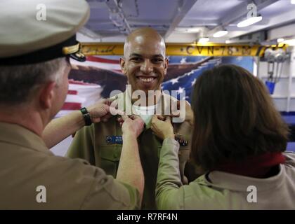 NEWPORT NEWS, Virginie (1 avril 2017) -- Le lieutenant Cmdr. Weston Coby, affecté à l'unité Pre-Commissioning Gerald R. Ford (CVN 78), est fixée au grade de lieutenant commander par sa femme et le Capitaine Richard McCormack, commandant du Ford, au cours d'une cérémonie de promotion sur Ford de fo'c'sle. Banque D'Images