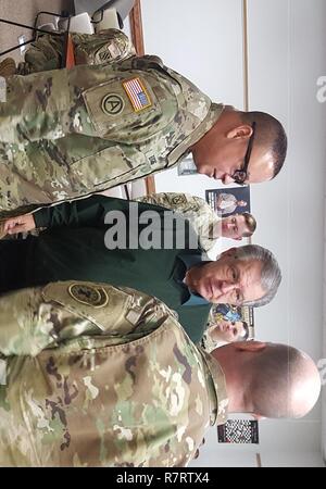 Le brig. Le général José R. Burgos (à gauche) de général commandant adjoint du Commandement du soutien régional 99e, Joint Base McGuire-Dix-Lakehurst, N.J., parle avec M. Melvin Bauman (milieu), Réserve de l'Armée de l'Ambassadeur de l'état du Michigan et de l'Armée Le sergent-chef. Jeffrey Cole (à droite), le sous-officier responsable des opérations pour l'armée américaine de recrutement des Grands Lacs bataillon, Lansing, Michigan, Mars 25, 2017, dans l'armée américaine George B. Dolliver Réserver Centre de Fort Custer Training Center, Michigan Bauman est un ancien lieutenant-colonel de réserve de l'Armée avec plus de 35 années de service. Banque D'Images