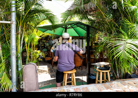 Paris, France - 1 mai 2018 : Les gens de manger de la nourriture au restaurant de style tropical jungle tables les touristes en Floride sur les voyages, journée ensoleillée, bar, l'homme jouant Banque D'Images