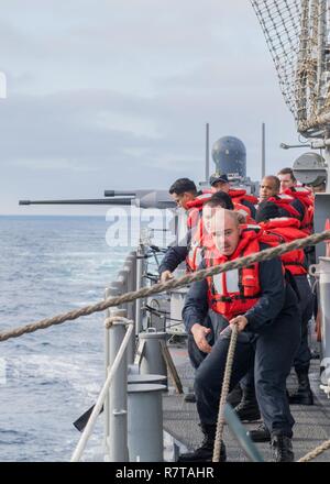 Océan Pacifique (6 avril 2017) Les marins à bord de la classe Ticonderoga croiseur lance-missiles USS Lake Erie (CG 70) ligne de poignée au cours d'un ravitaillement en mer pendant qu'ils sont en cours la réalisation d'une unité de formation composite (exercice COMPTUEX) avec le groupe aéronaval du Nimitz en préparation pour un prochain déploiement. COMPTUEX teste l'état de préparation à la mission de la grève actifs du groupe grâce à une simulation des scénarios du monde réel et leur capacité à fonctionner comme une unité intégrée. Banque D'Images