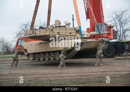 Un M1A2 Abrams tank est éteint chargés depuis un véhicule de transport près de Galati, Roumanie, Avril 5, 2017 pour les prochains exercices de tir réel avec des soldats américains et des forces terrestres de la Roumanie . Les soldats américains qui feront fonctionner le réservoir sont de la Compagnie Charlie, 1er Bataillon, 8e Régiment d'infanterie, 3e Brigade Combat Team, 4e Division d'infanterie. La formation conjointe aura recours à un système de ciblage nouvellement installée, qui peut déplacer une silhouette réservoir cible à une vitesse de 20 milles à l'heure pour jusqu'à 340 mètres. Banque D'Images