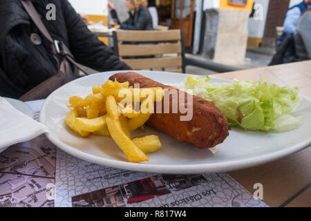 Flamenquín de frites sur une assiette blanche en terrasse extérieure, restaurant, tapas, Cordoba, Espagne. Banque D'Images