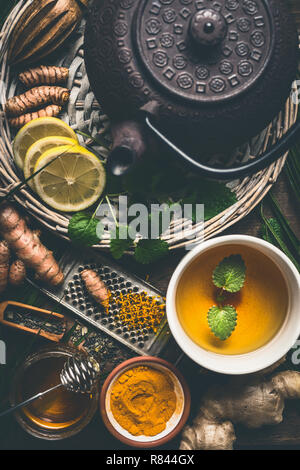 Tasse de thé épice curcuma sain avec théière et ingrédients : citron, le gingembre, la cannelle et le miel , vue d'en haut. Remède stimulant immunitaire , d Banque D'Images