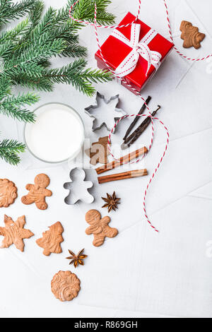 Noël gingerbread cookies faits maison délicieux avec un verre de lait, les épices, la cannelle et anis étoile, Metall coupeuses et don sur le fond blanc Banque D'Images