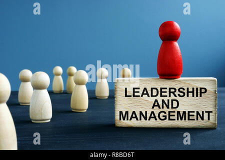 Leadership et gestion écrit sur un bloc de bois. Banque D'Images
