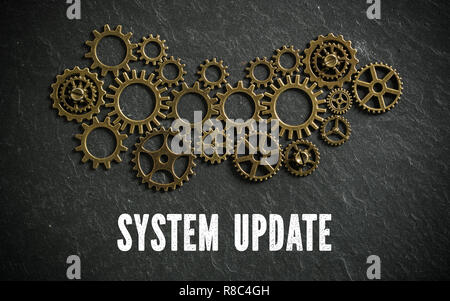 Roues dentées et les mots 'system update' sur fond d'ardoise symbolisant un système complexe à travailler ensemble Banque D'Images