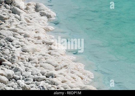 La partie sud de la Mer Morte, est divisé en pools d'où extraire les minéraux. La côte rocheuse est recouvert de cristaux de sel blanc lavé par th Banque D'Images