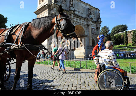 ROME, ITALIE - 09 octobre, 2018 : un homme en fauteuil roulant à l'extérieur profiter de vacances romaines. Sur le fond l'Arc de Constantin et le cheval pour th Banque D'Images