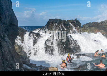 Le Parc national Arikok Aruba Aruba Conchi - piscine naturelle - de l'impact des vagues massives de snorkeling et les touristes visitant une attraction touristique populaire Banque D'Images