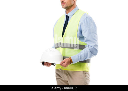 Portrait de l'ingénieur en sécurité vest holding helmet isolated on white Banque D'Images