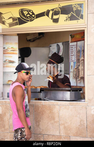 L'homme sur téléphone attend au stand de restauration rapide passe à La Havane Cuba Banque D'Images