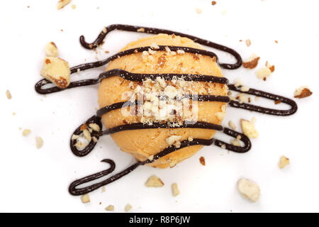 La crème glacée jaune avec du chocolat fondu dessus isolé sur fond blanc Banque D'Images