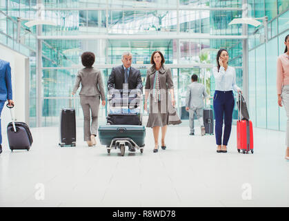 Les gens d'affaires à marcher avec assurance dans l'aéroport Banque D'Images
