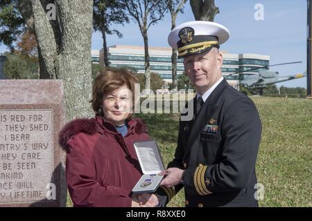 PENSACOLA, Floride -- Mme Jacqueline Hoffman, la nièce de l'ens de la Garde côtière des États-Unis. David A. Hoffman qui a été tué à bord-côte de la Garde côtière canadienne (CCG) Tampa le 26 septembre 1918, à titre posthume, accepte la Purple Heart .de Centre de soutien opérationnel de la Marine (CNTO) commandant le Cmdr. Jeff Hodges au cours d'une cérémonie à Veteran's Memorial Park de Pensacola, Floride, 7 décembre. Hoffman était à bord le USCGC Tampa lorsqu'il a été frappé par une torpille allemande près de la fin de la Première Guerre mondiale, tuant tous à bord. Banque D'Images