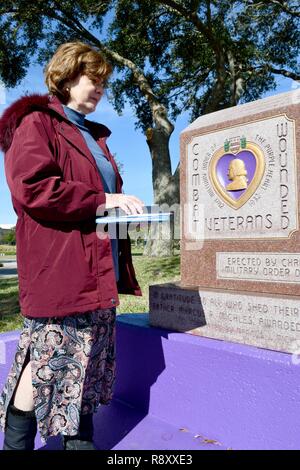 PENSACOLA, Floride -- Mme Jacqueline Hoffman, la nièce de l'ens de la Garde côtière des États-Unis. David A. Hoffman qui a été tué à bord-côte de la Garde côtière canadienne (CCG) Tampa le 26 septembre 1918, à titre posthume, accepte la Purple Heart .de Centre de soutien opérationnel de la Marine (CNTO) commandant le Cmdr. Jeff Hodges au cours d'une cérémonie à Veteran's Memorial Park de Pensacola, Floride, 7 décembre. Hoffman était à bord le USCGC Tampa lorsqu'il a été frappé par une torpille allemande près de la fin de la Première Guerre mondiale, tuant tous à bord. Banque D'Images