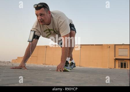 Aumônier (Maj) Jack Miller, 379e Escadre expéditionnaire de la force, de l'aumônier s'étend avant une séance d'entraînement le 6 décembre 2018, à Al Udeid Air Base, au Qatar. Miller a reçu un diagnostic de cancer surrénalien en 2012 et par les médecins ont dit qu'il n'aurait jamais des distances plus longues encore. Lors d'un déploiement à l'Al Udeid, Miller entraînés depuis des mois et a pu terminer la journée des anciens combattants de la base 5K, 11 novembre 2018. Banque D'Images