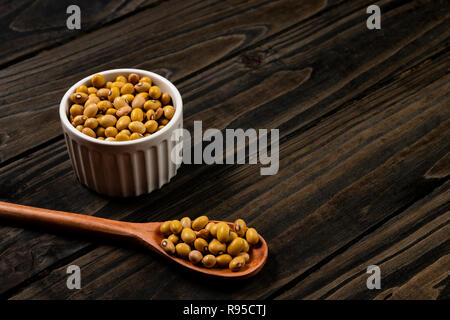 Boules de haricots dans la casserole. Fond noir en bois. Banque D'Images