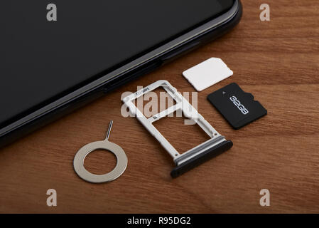 La carte SIM et de carte microSD avec outil de dépose sur le côté de smartphone Blackberry Banque D'Images