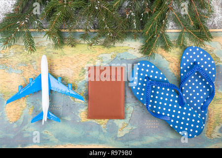 Concept de Noël - voyage. Branches de sapin avec de la neige, des cartes, passeport, tongs et toy airplane Banque D'Images