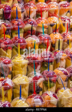 Diverses sortes de fruits frais dans des gobelets en plastique pour la préparation de boissons smoothie. Boire des boissons fruitées et colorées. Banque D'Images