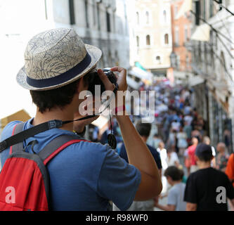 Le jeune photographe avec hat prend de nombreuses photos à Venise Italie en été Banque D'Images