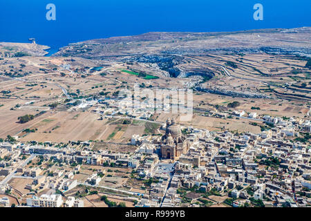 La rotonde de Xewkija (Casal Xeuchia) est le plus grand de Gozo et son dôme domine l'île partout. Mgarr ix-Xini bay en arrière-plan. L'île de Gozo rural comme vu du dessus. Vue aérienne de Malte. Banque D'Images